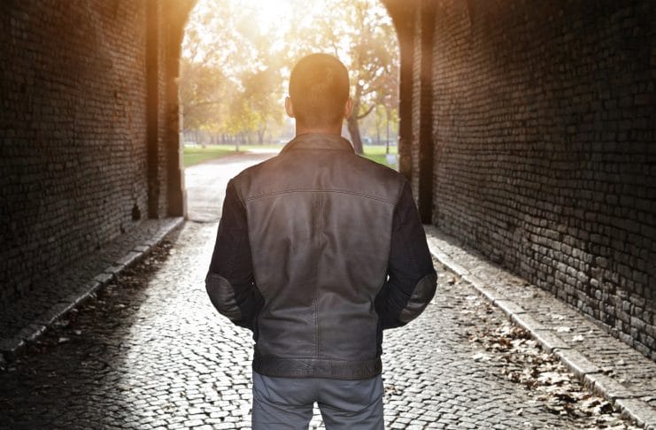 Man standing alleyway