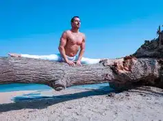 Man doing the splits on a log