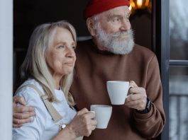 Man and women holding a cup