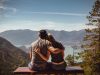 man and woman sitting on bench