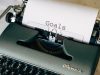green typewriter on brown wooden table