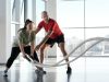 a woman holding ropes beside a trainer