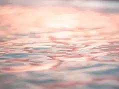 rippling seawater reflecting pink evening sky